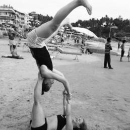 Christina Liljeroth acro yoga on beach smiling